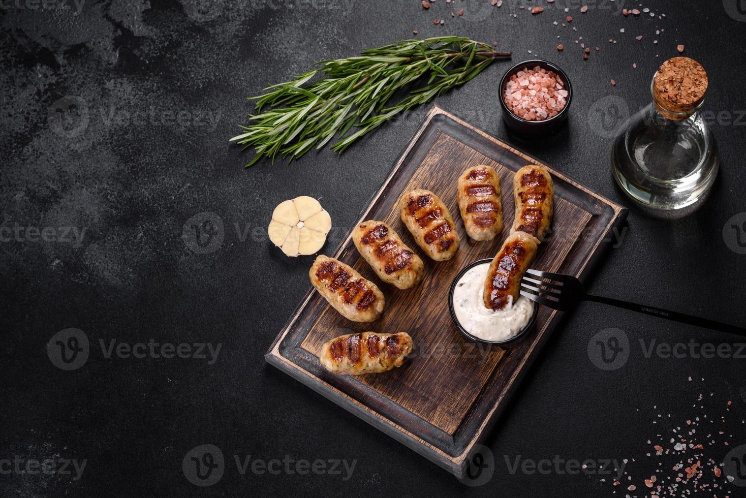 Grilled sausage with the addition of herbs and vegetables photo