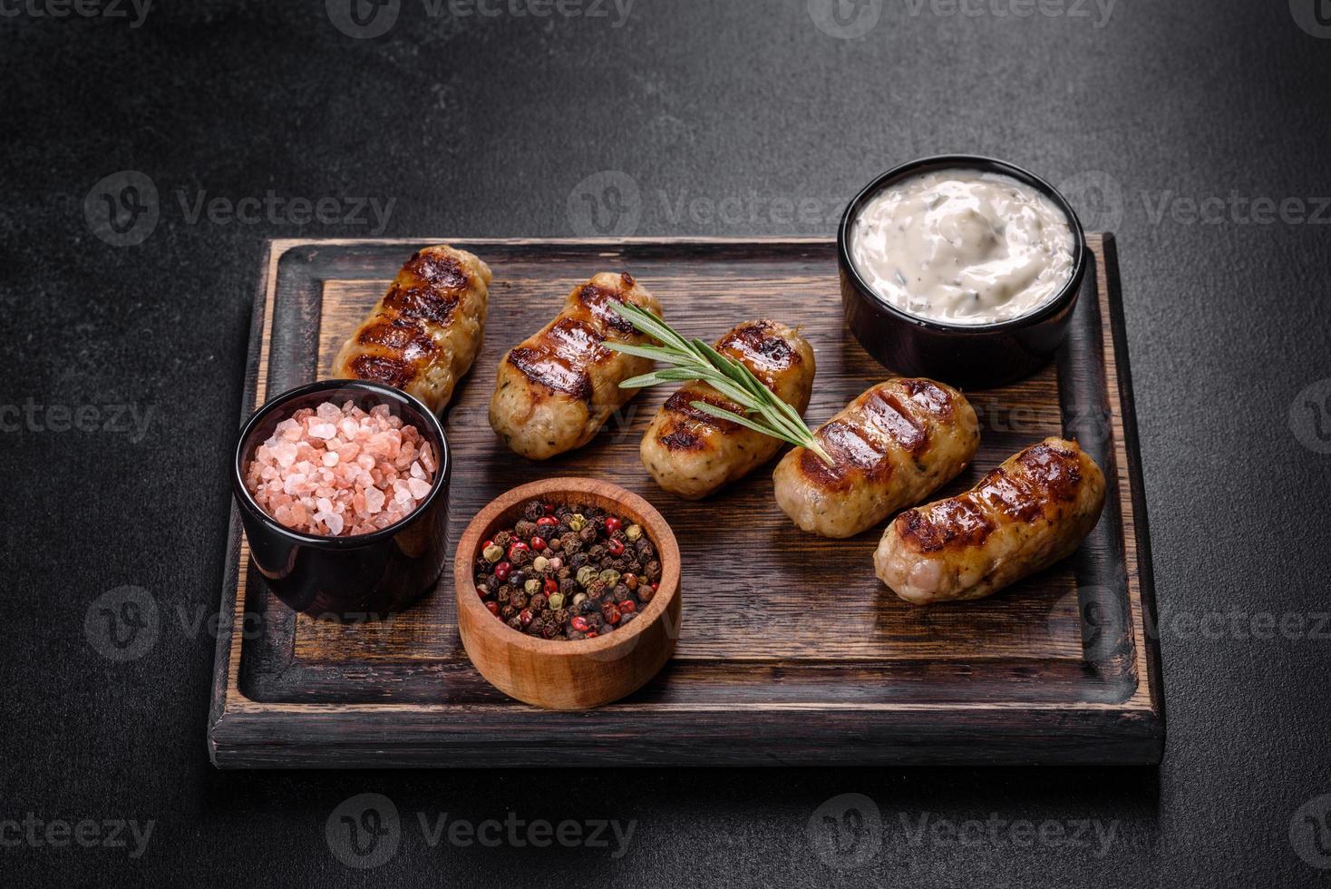 Grilled sausage with the addition of herbs and vegetables photo