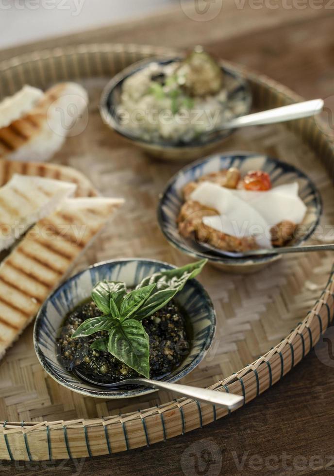 Vegetarian Turkish mezze snack tapas platter on rustic wood restaurant table photo