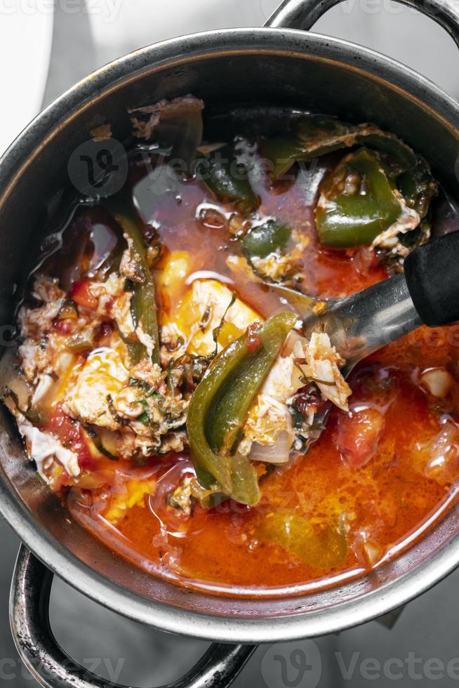 Traditional spicy tomato vegetable and egg soup stew in madeira Portugal photo