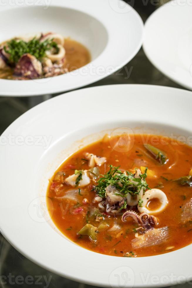 Caldeirada de lulas squid seafood stew soup in spicy tomato and vegetable sauce in Lisbon restaurant photo