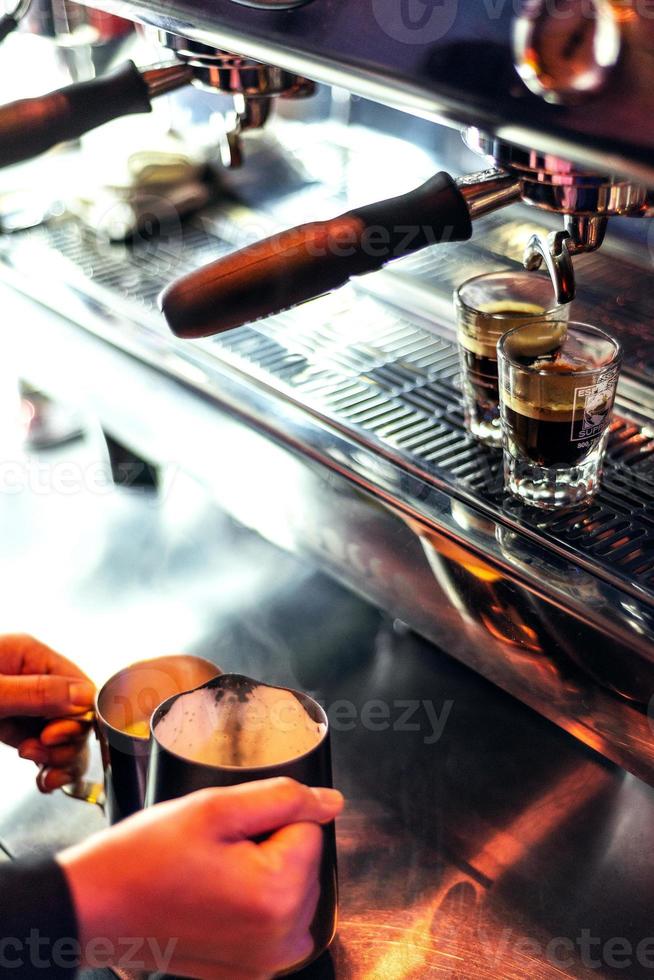 Making espresso coffee close up detail with modern cafe machine photo