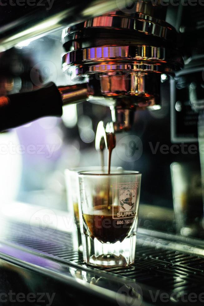 Making espresso coffee close up detail with modern cafe machine photo