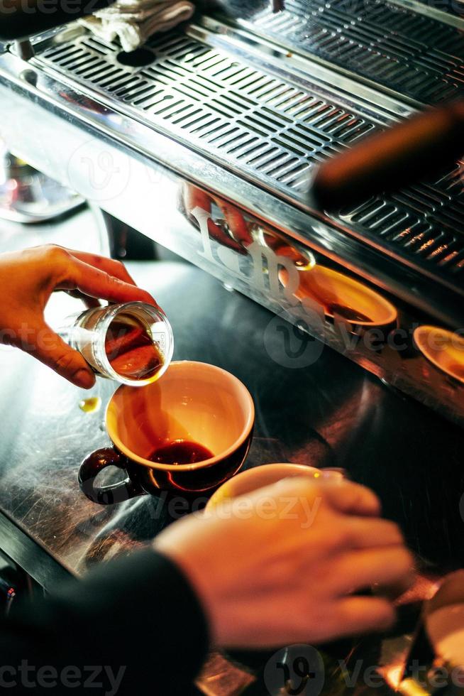 Making espresso coffee close up detail with modern cafe machine photo