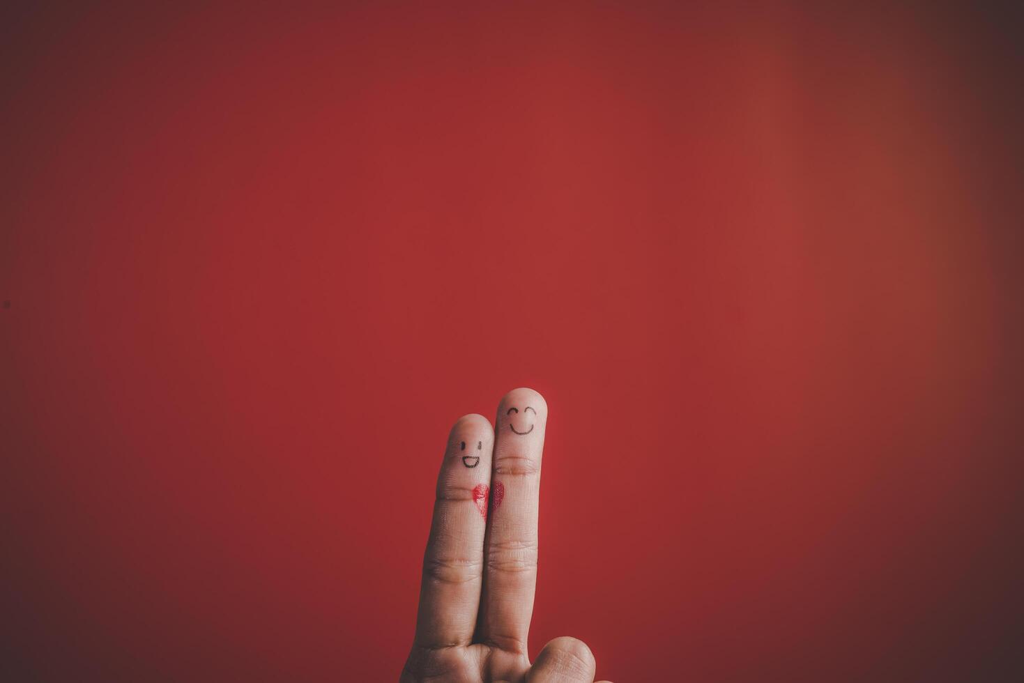 Finger with emotion on red background. photo