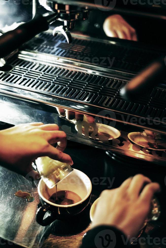 Making espresso coffee close up detail with modern cafe machine photo