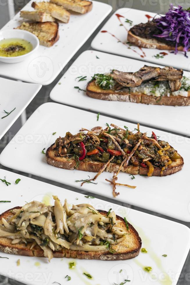 Portuguese traditional tiborna toasted open sandwich tapas snacks on table photo