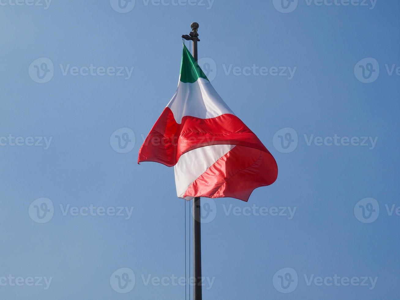 Italian flag over blue sky photo