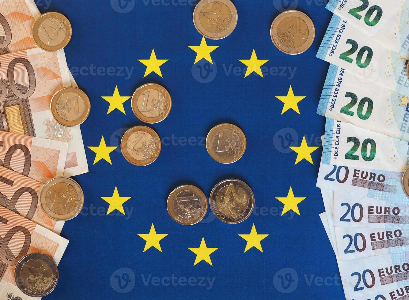 Euro notes and coins, European Union, over flag photo