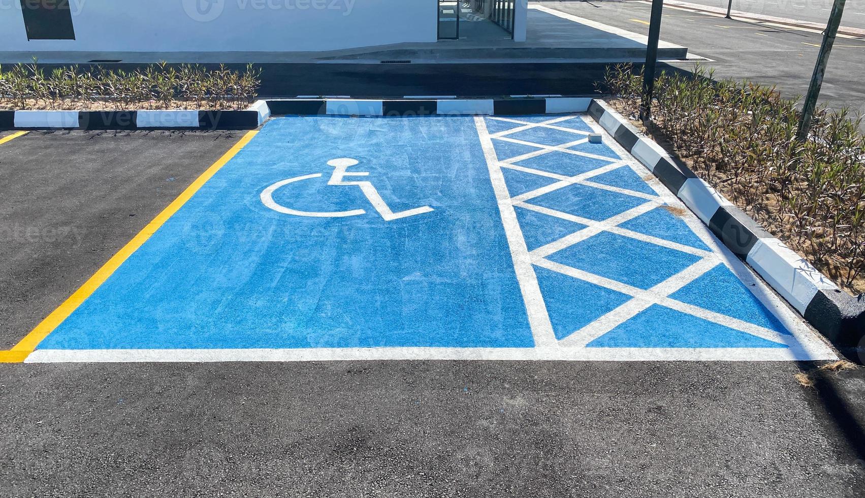 View of a disabled car park colored in bright blue paint photo