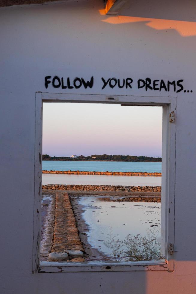 White house with message Follow yours Dreams, in Las Salinas. photo