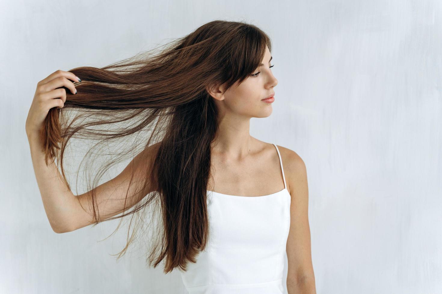 happy smiling womanly brunette lady holding her straightness photo