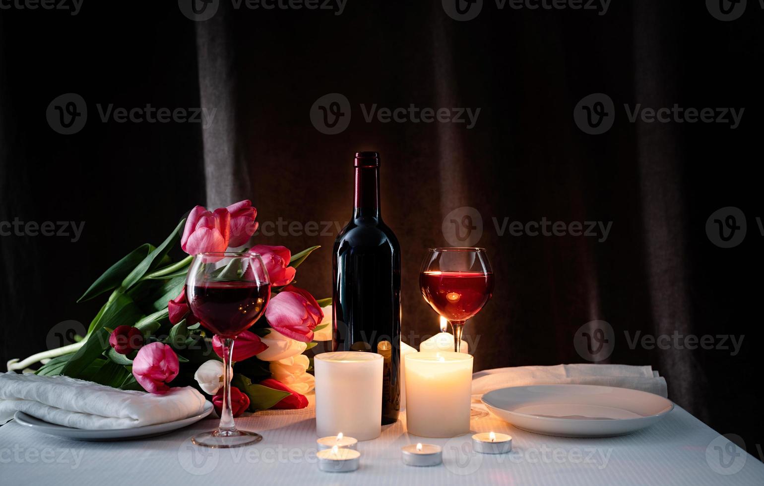 Romantic candlelight dinner for two lovers, dark background photo
