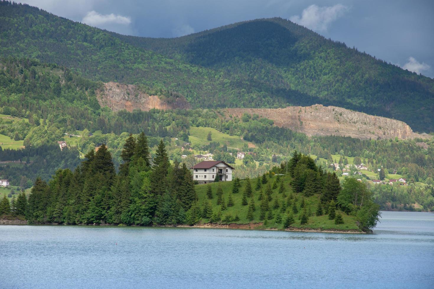 A white cottage on the island of Colibita Lake photo