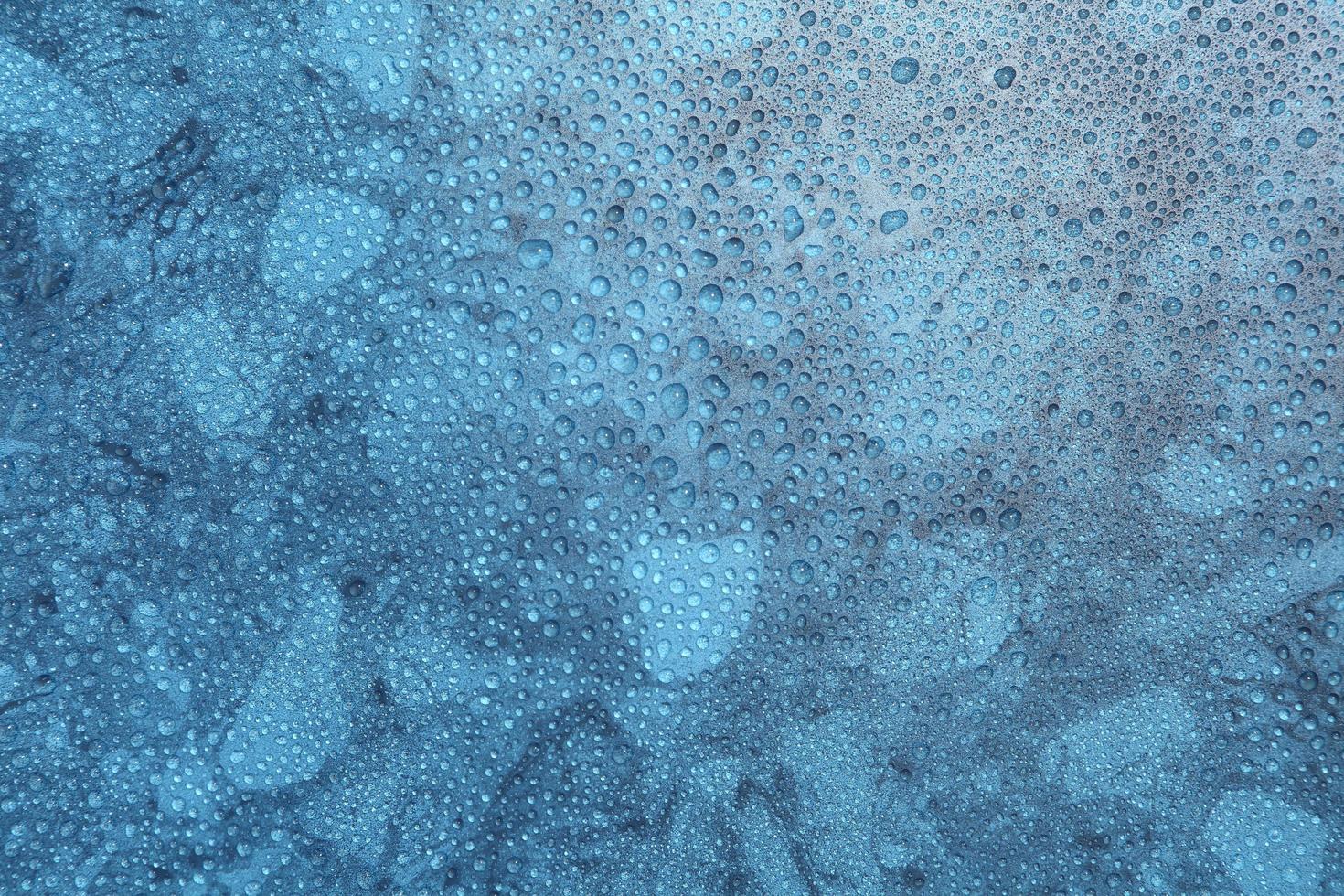 Close up water drops on blue background photo