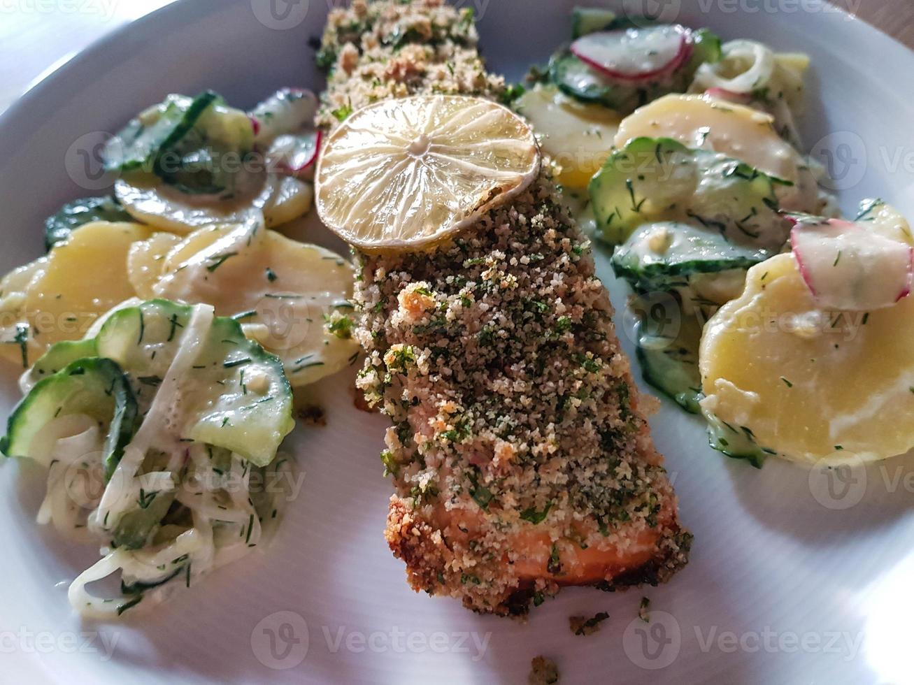 Salmon steak with potato salad photo