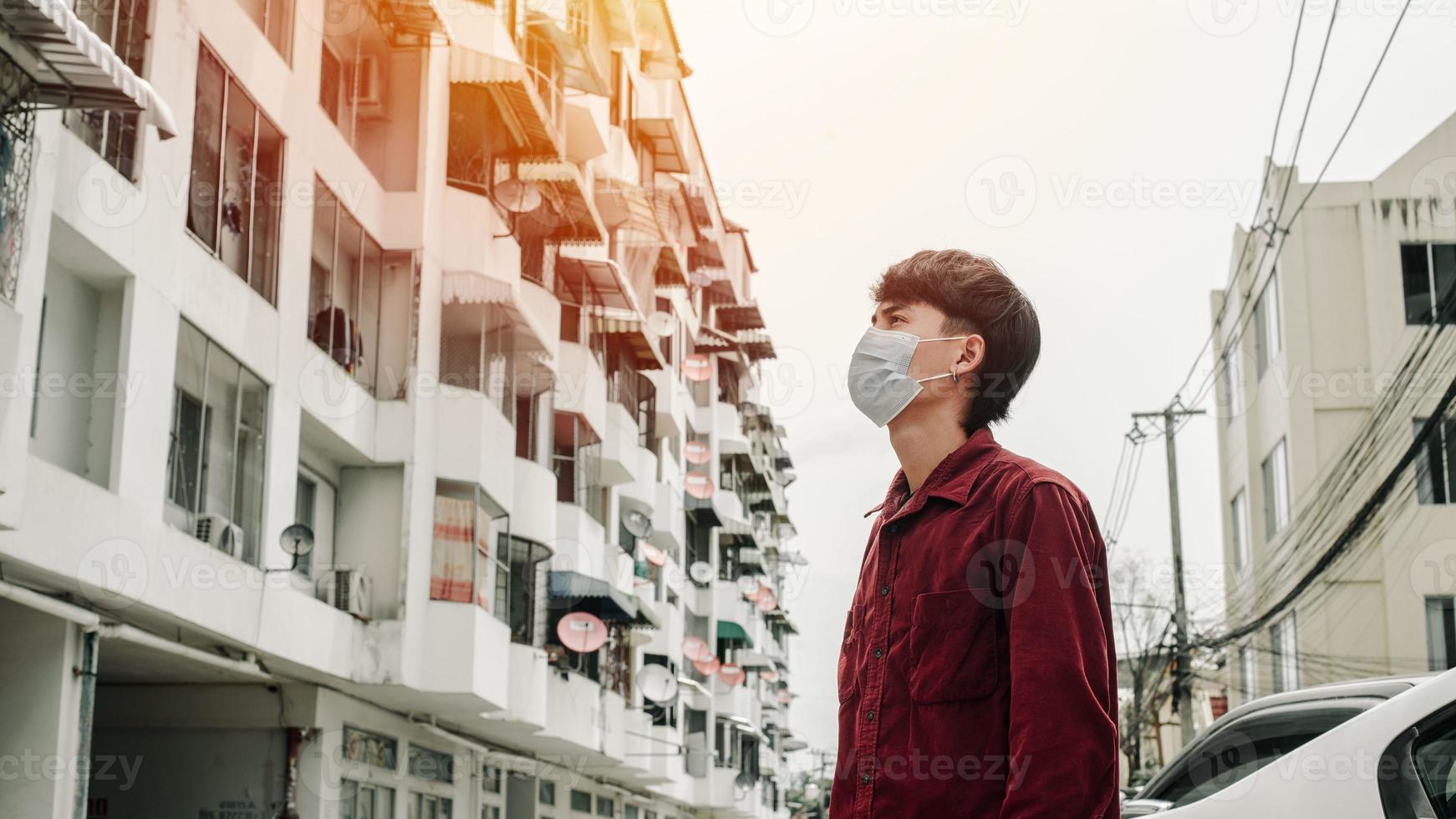 Man with medical face mask in the city. Air pollution. photo