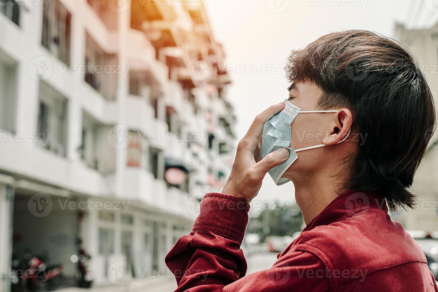 Man with medical face mask in the city. Air pollution. photo