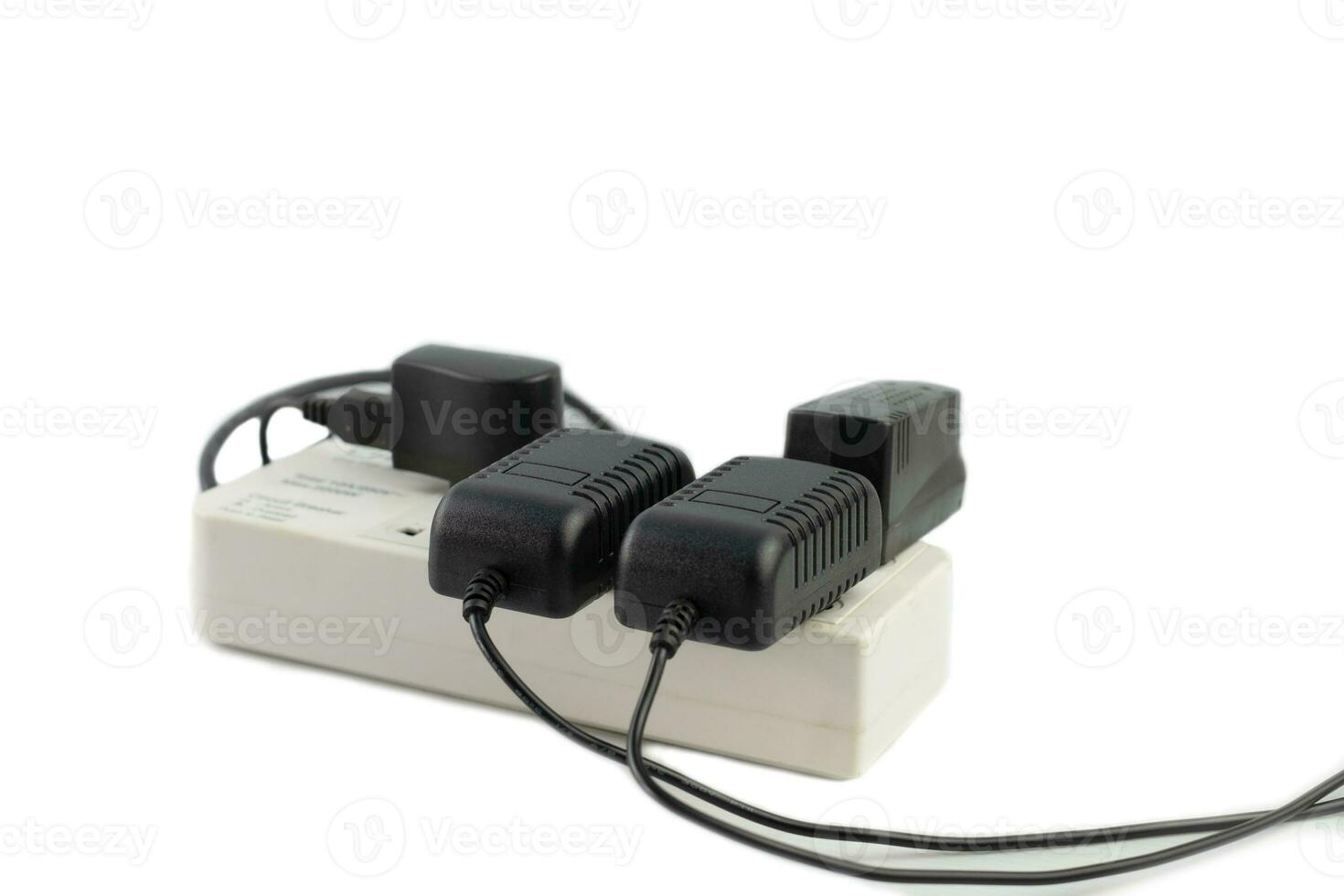 Multiple sockets with connected power strip with a bunch of plugs and adapter on white background photo