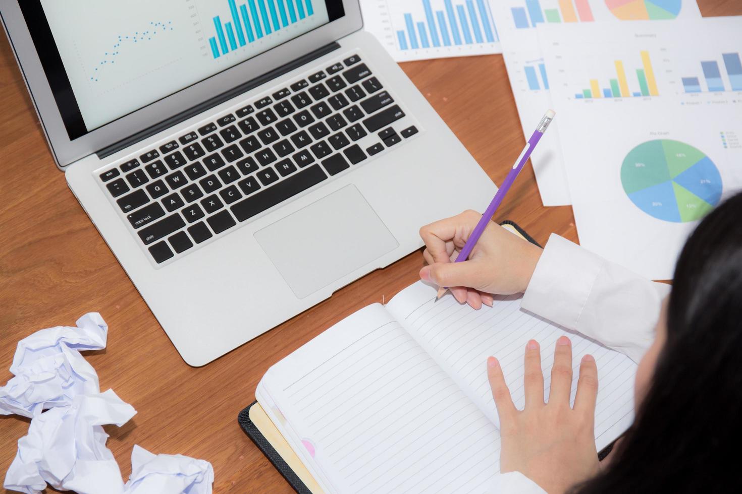 Business woman writing on notebook at desk. photo