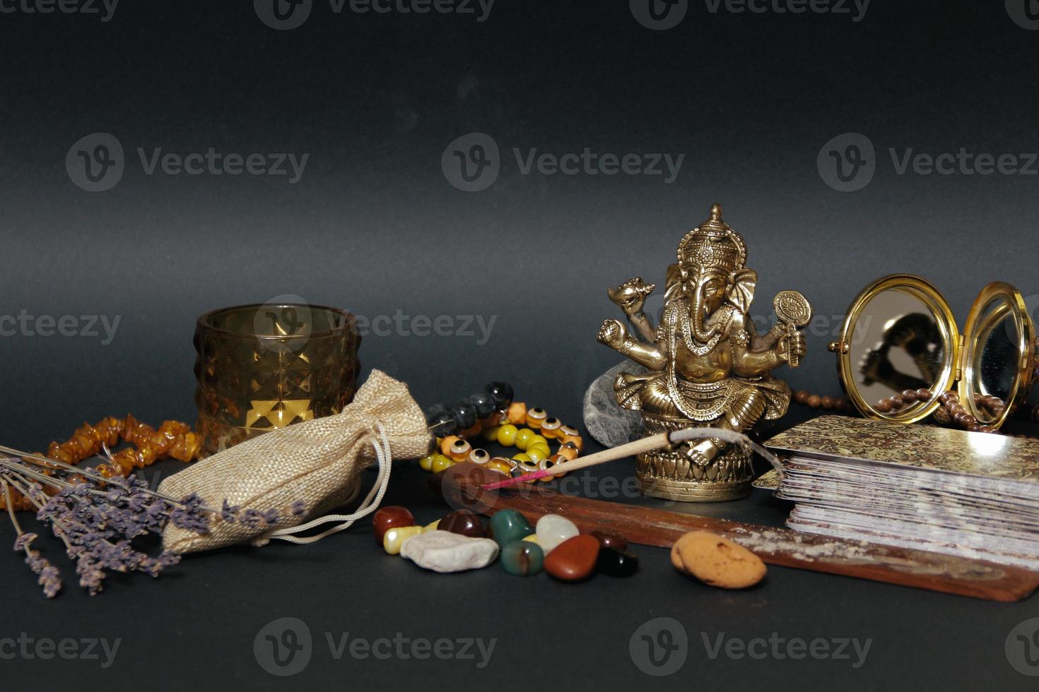 Table with occult attributes, top view. Ganesha figurine, photo