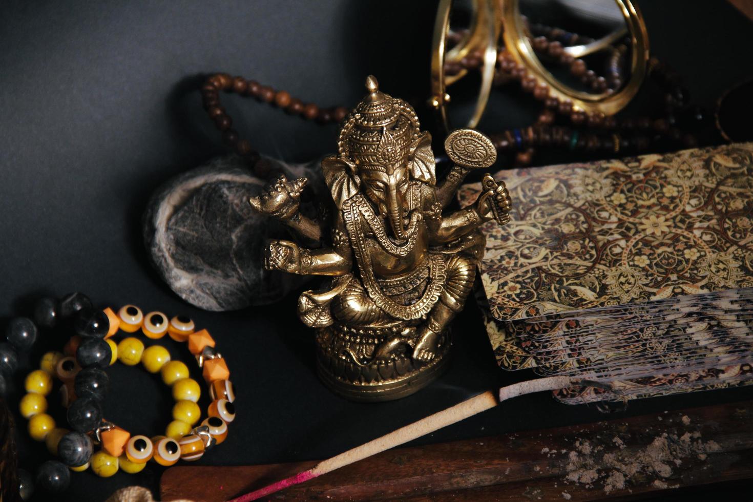 Table with occult attributes, top view. Ganesha figurine, photo