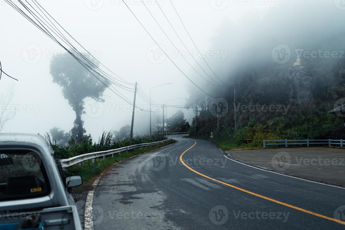 Mountain road in rainy and foggy day photo