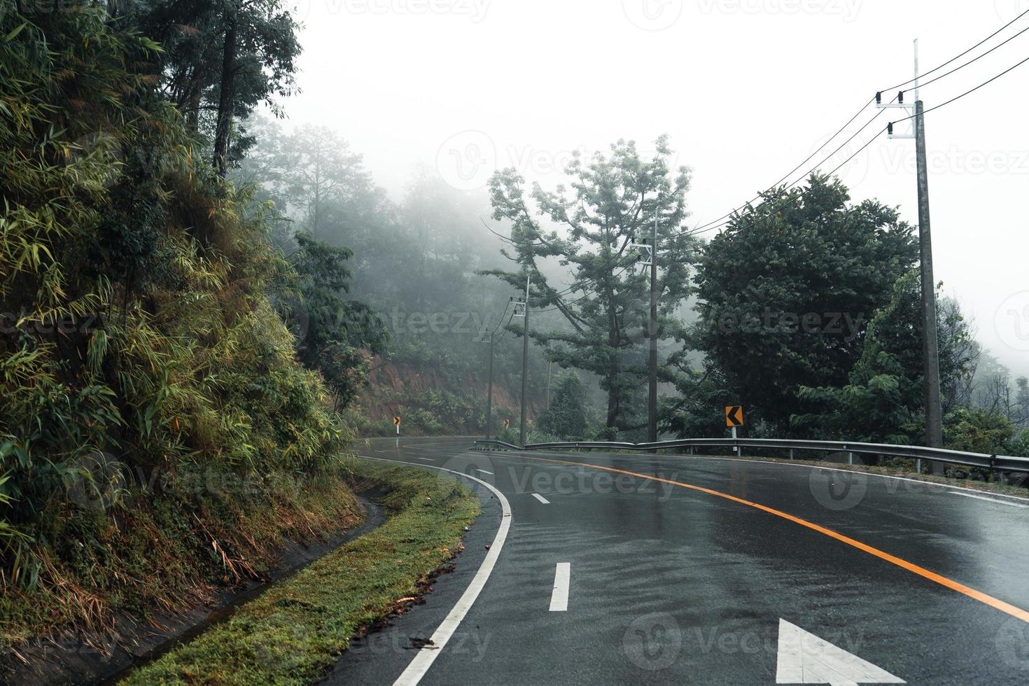 Mountain road in rainy and foggy day photo