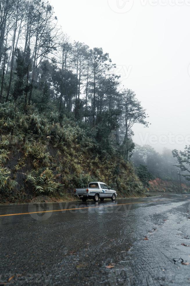 Mountain road in rainy and foggy day photo