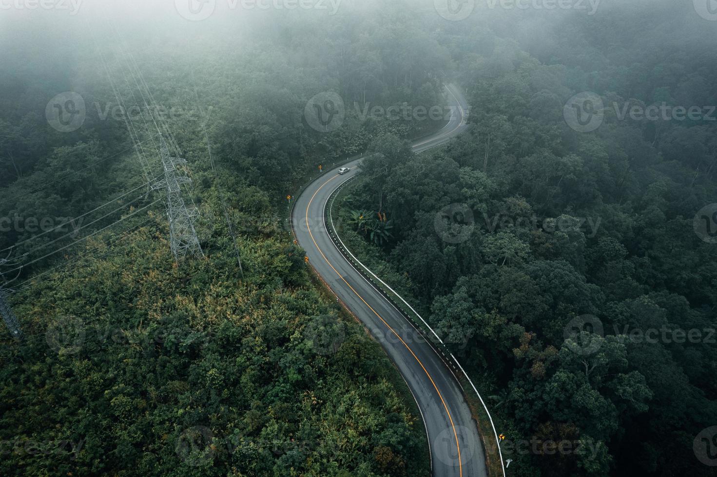 Mountain road in rainy and foggy day photo