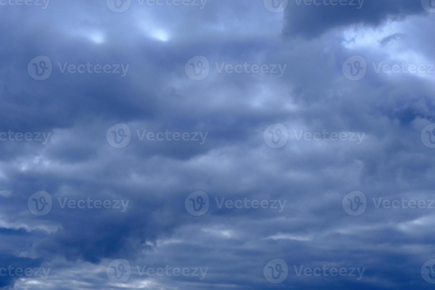 dramatic high deep blue sky with fluffy clouds photo