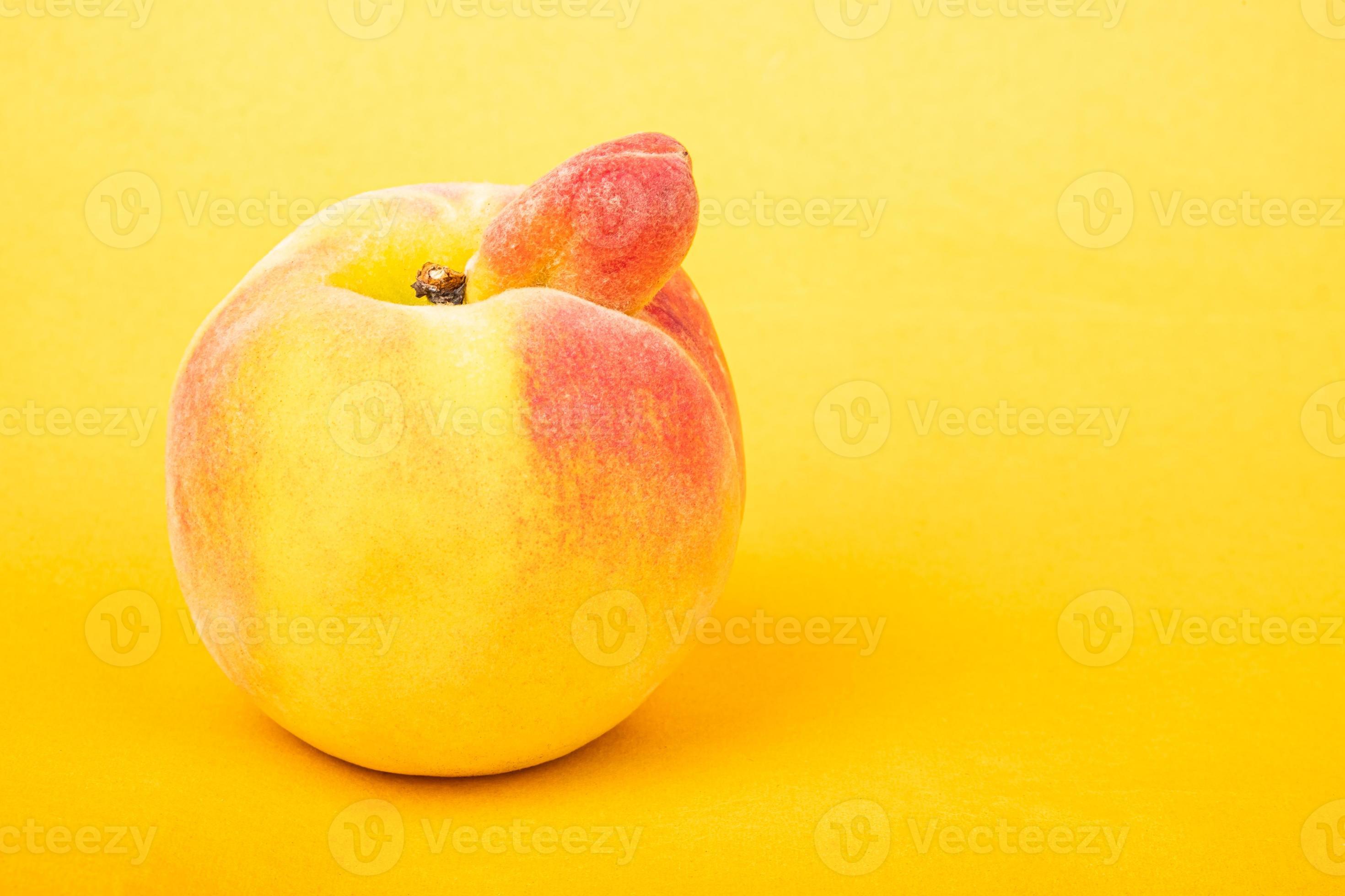 Peach sexy fruit of an unusual shape with copy space on yellow background.  3246952 Stock Photo at Vecteezy