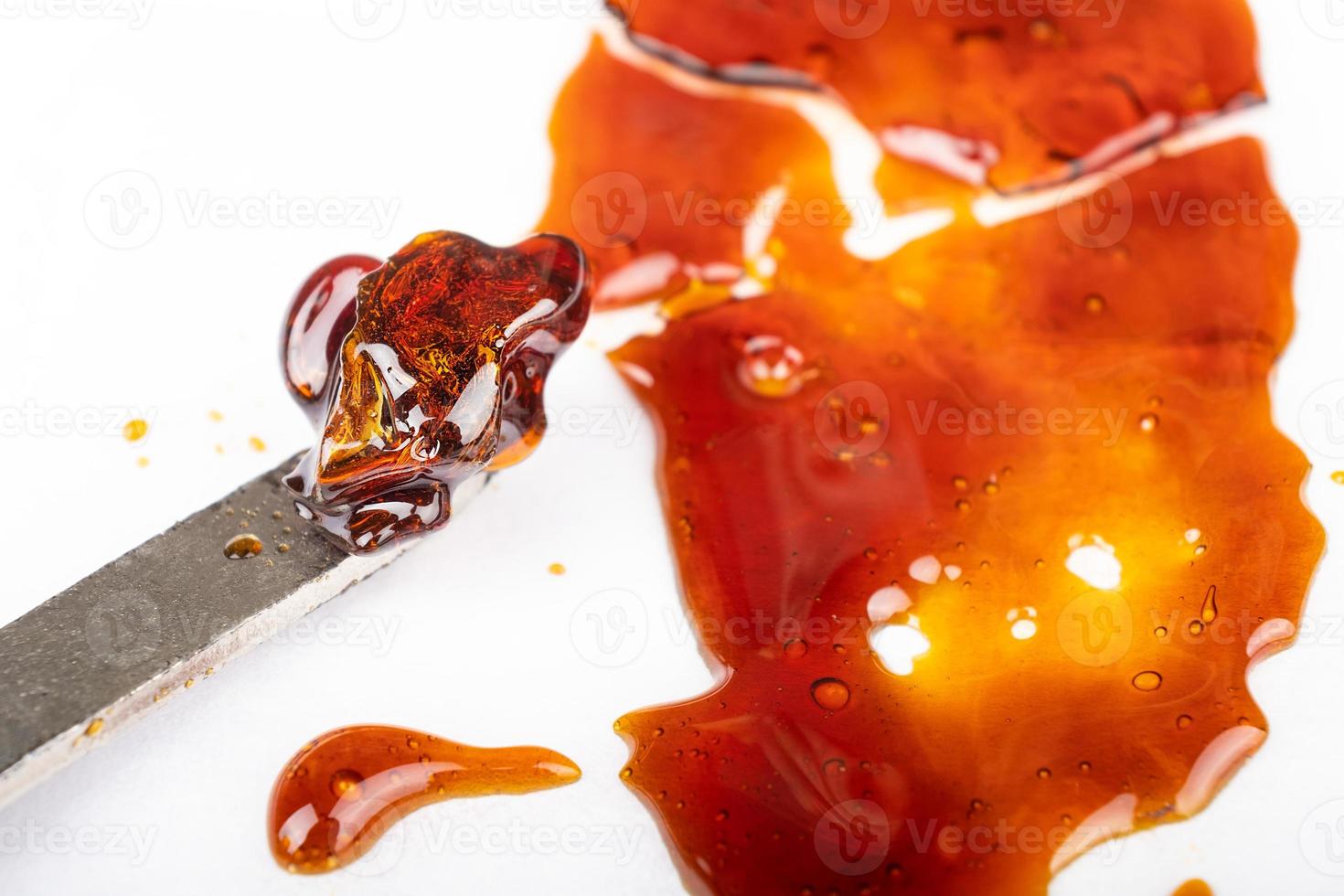 Dial cannabis wax with a metal stick for smoking concentrate, dab tool marijuana. photo