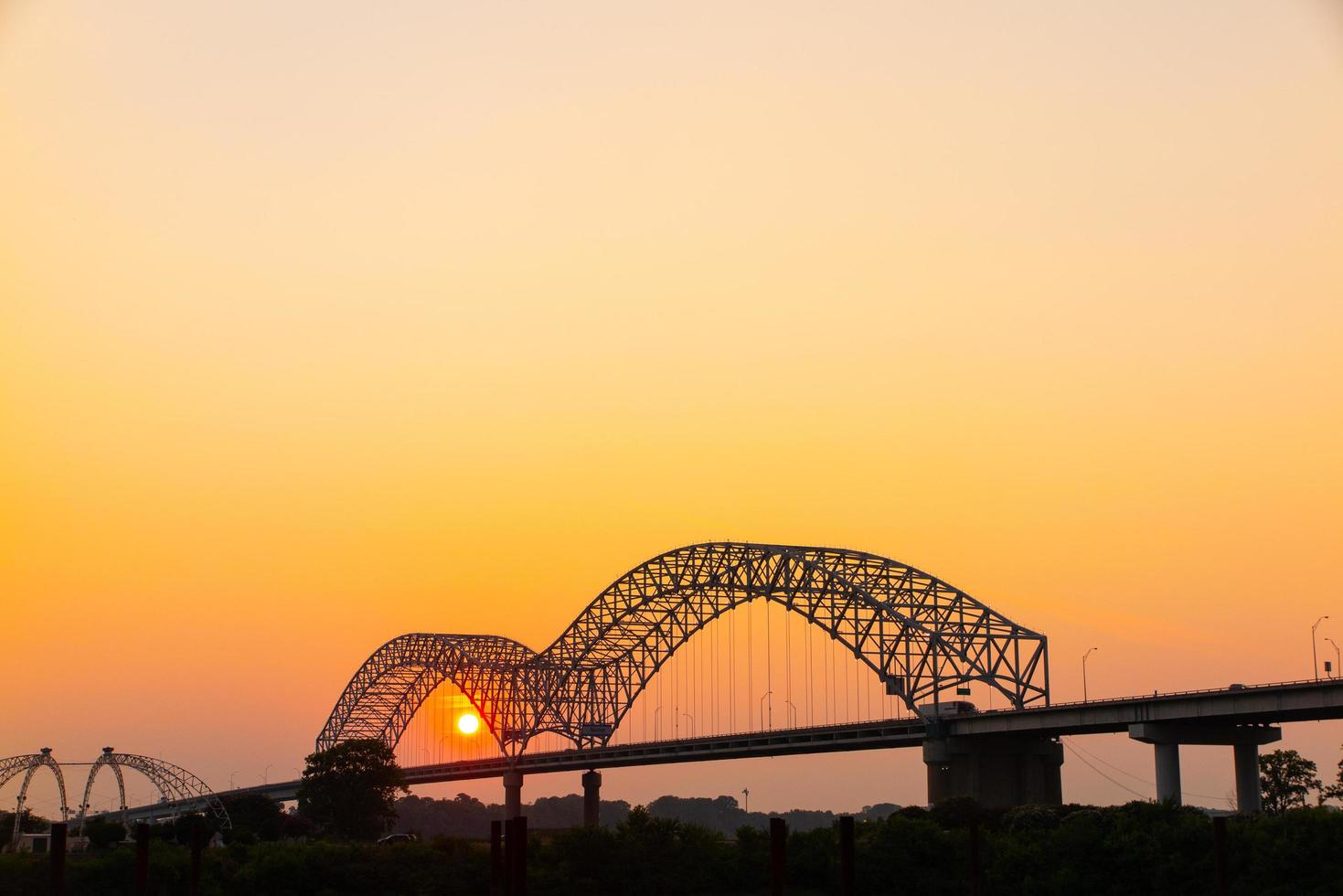 Hernando Desoto Bridge on the Mississippi River at dusk photo