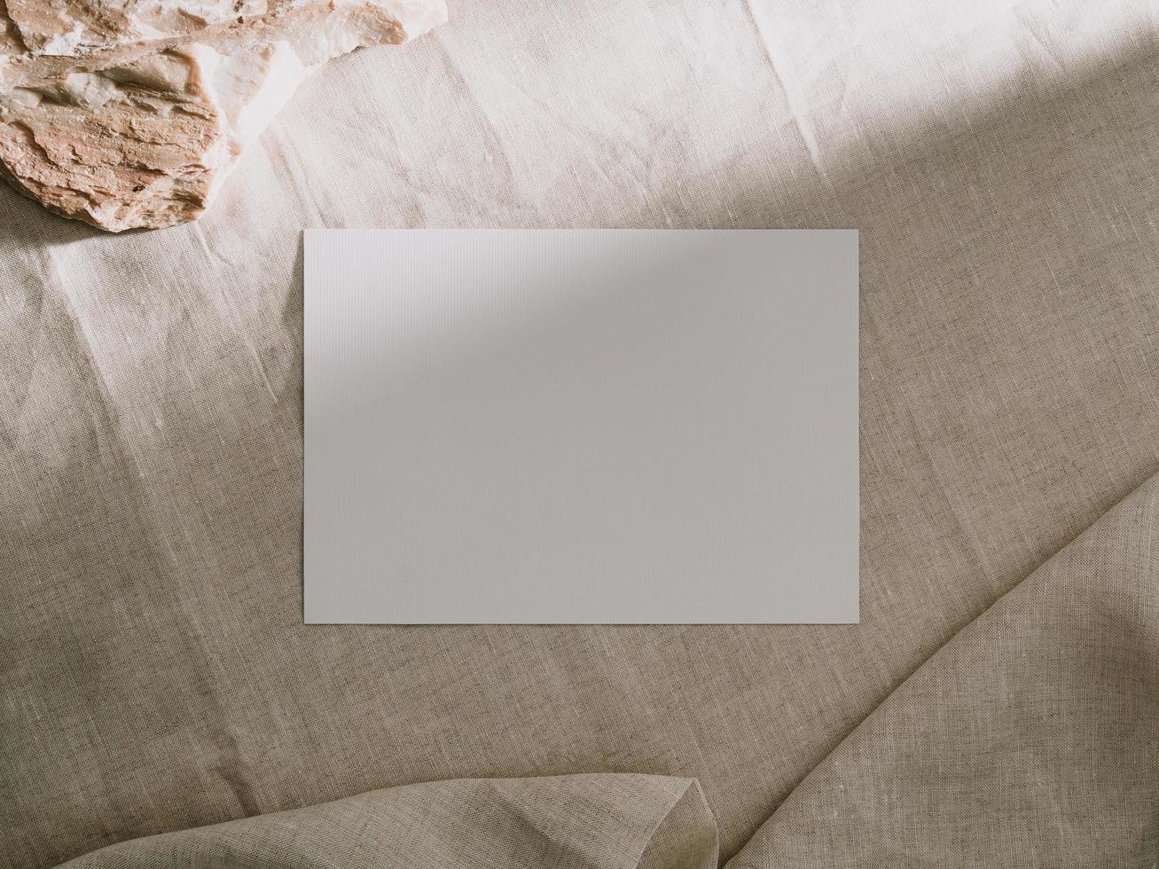 Invitation card mockup, blank greeting card template. Flat lay photo
