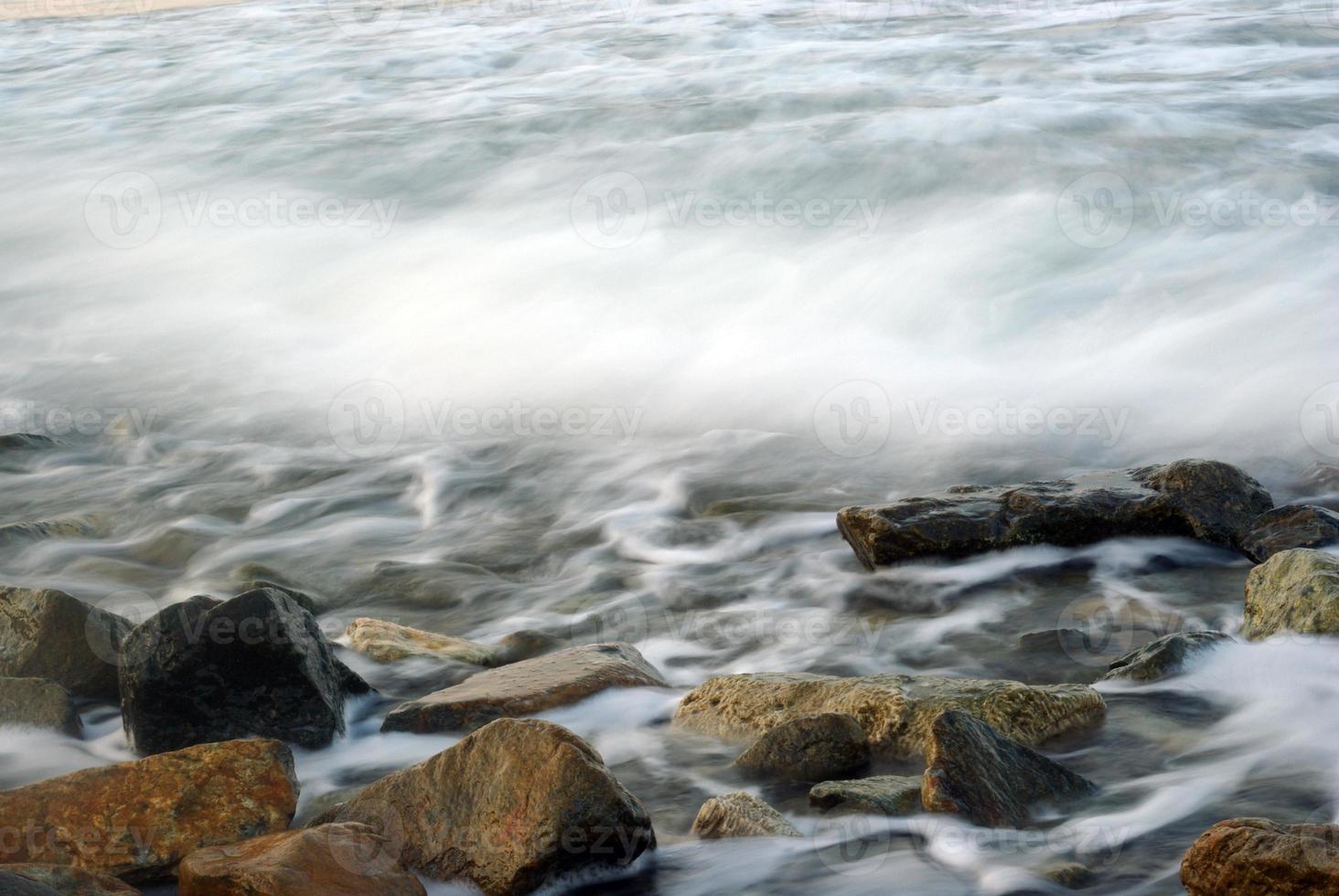 Turbulence sea water and rock at Coastline photo