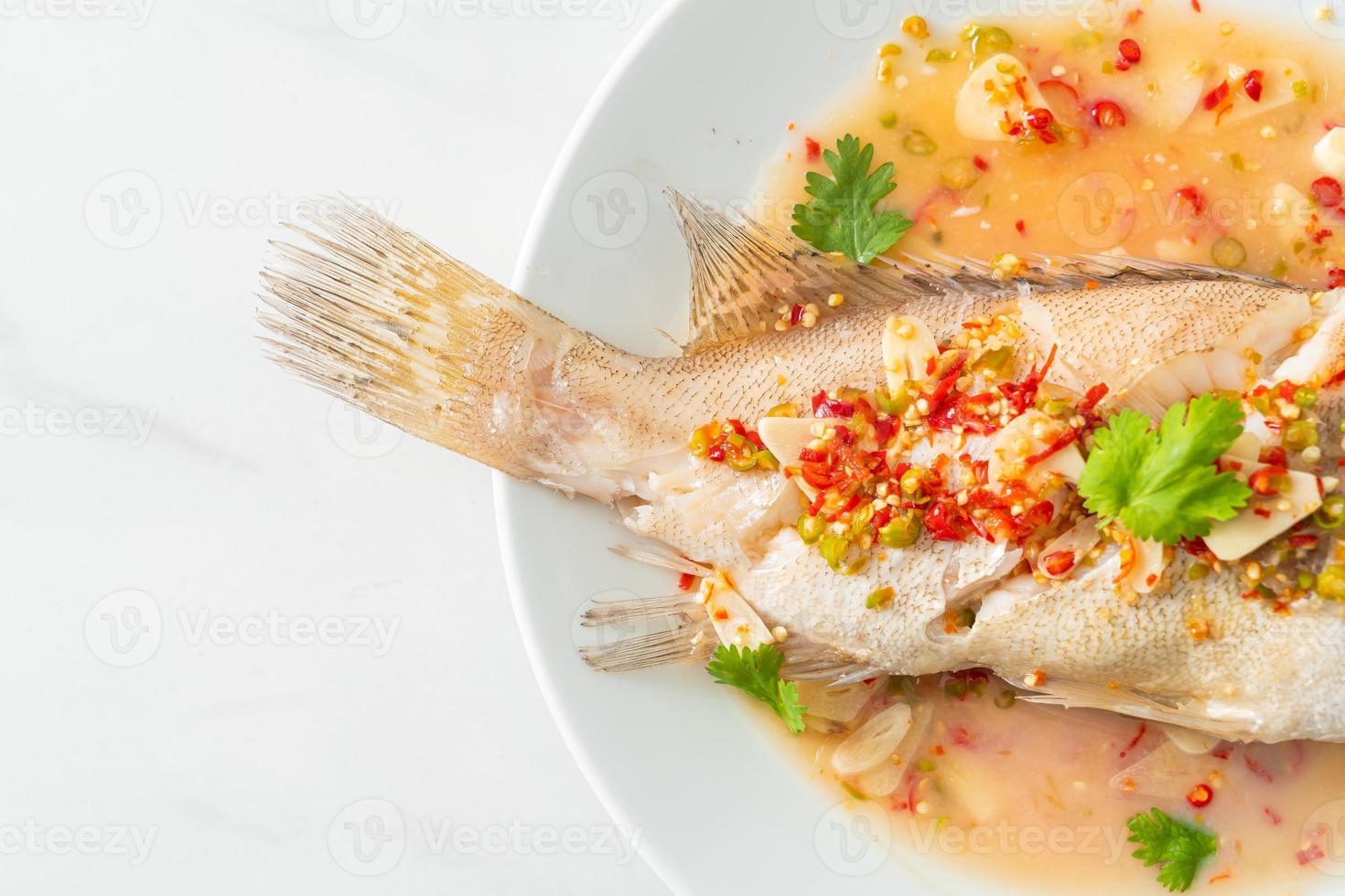 Steamed grouper fish with lime and chillies photo