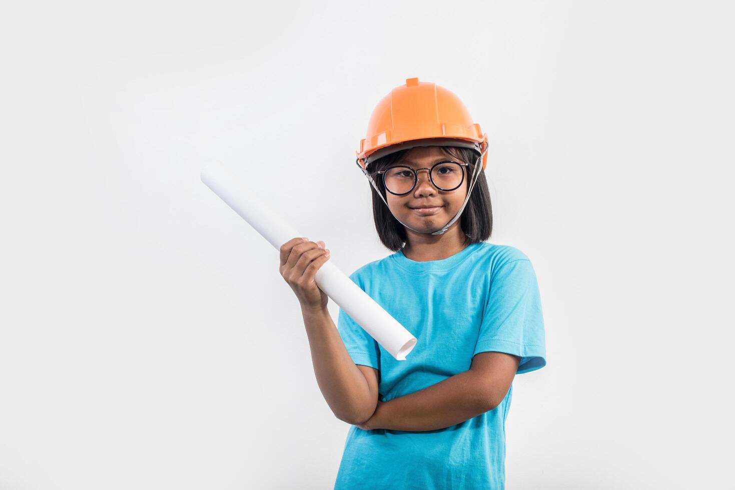 Little girl wearing orange helmet in studio shot. photo