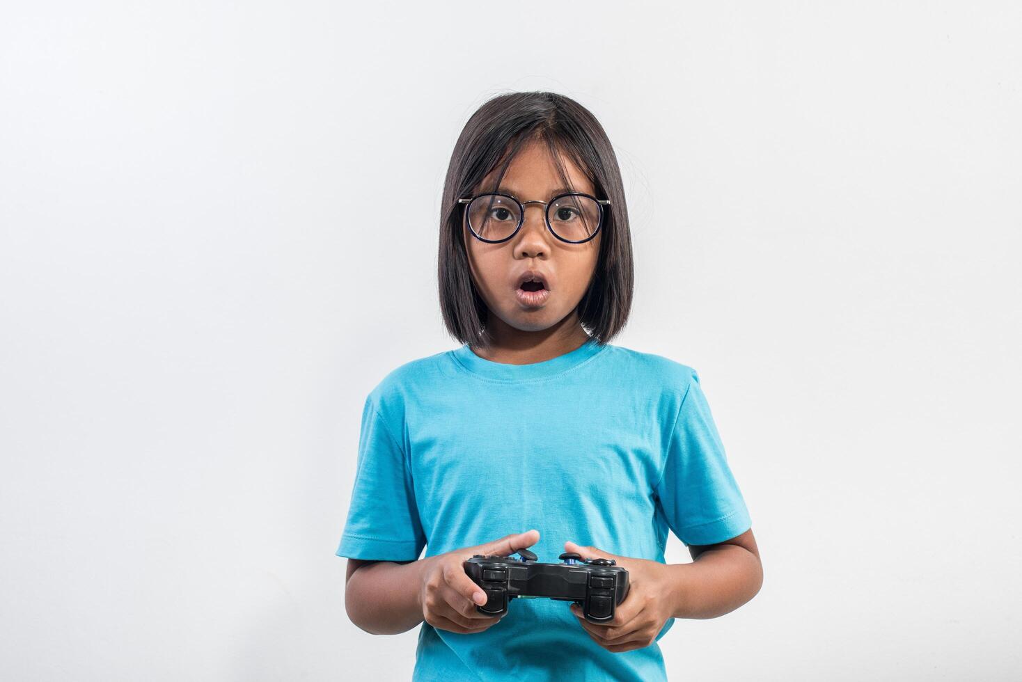 Portrait of little girl with joystick gamer. photo