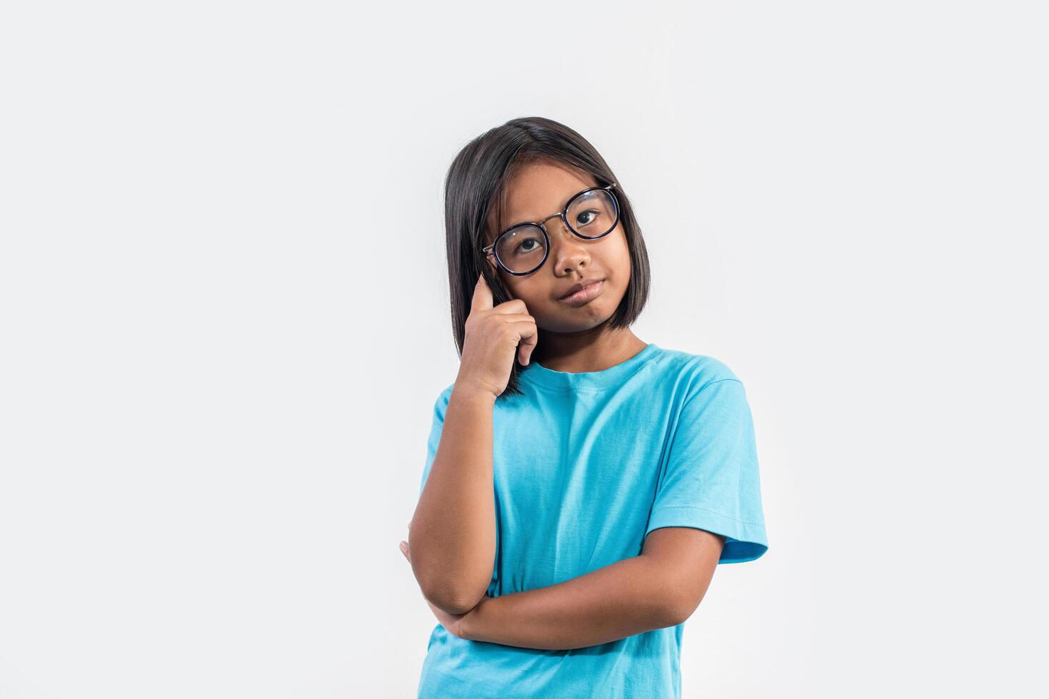 Little girl thinking in studio shot. photo