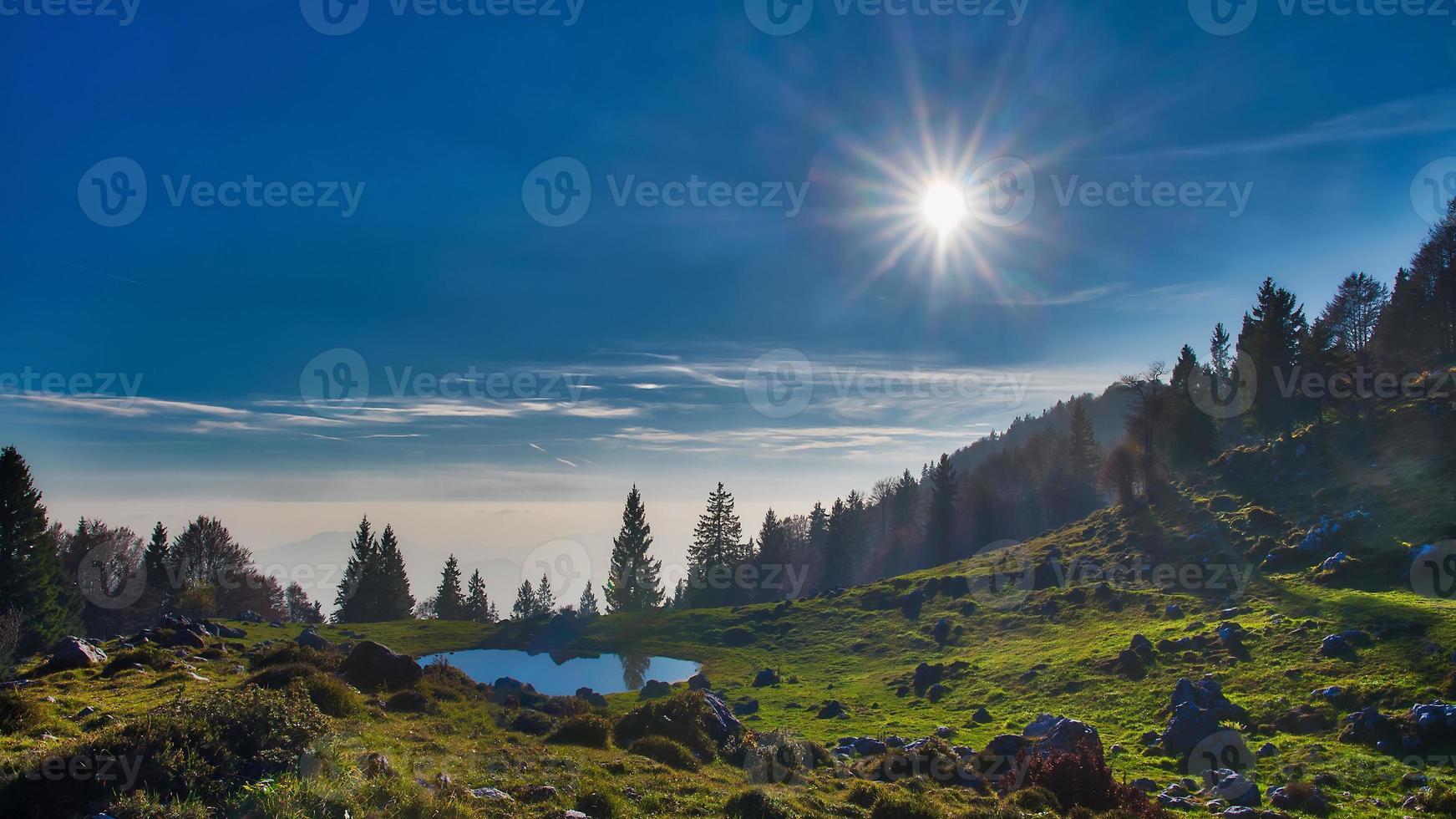 Alpine landscape with a small lake photo