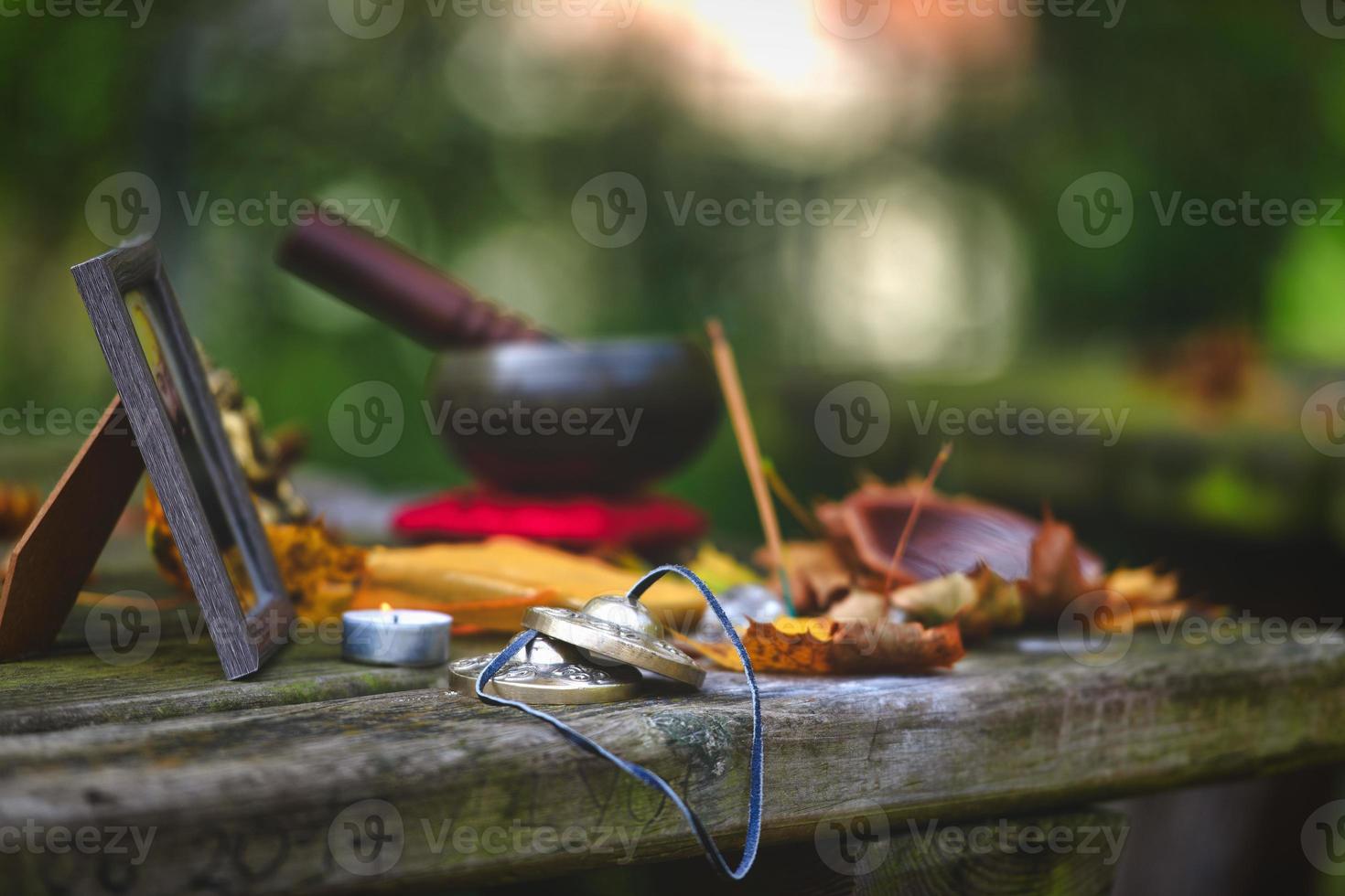 Yoga meditation objects on wooden table outdoors photo