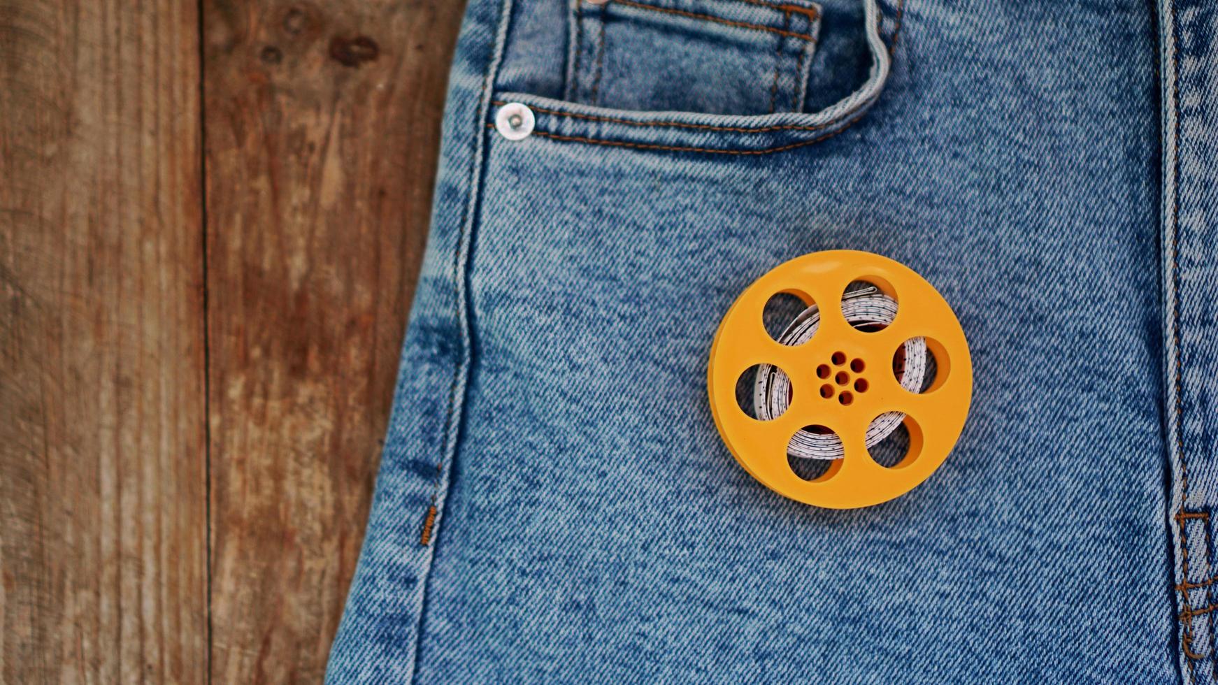 Blue jeans and a measuring tape. Slimming or sewing denim concept photo