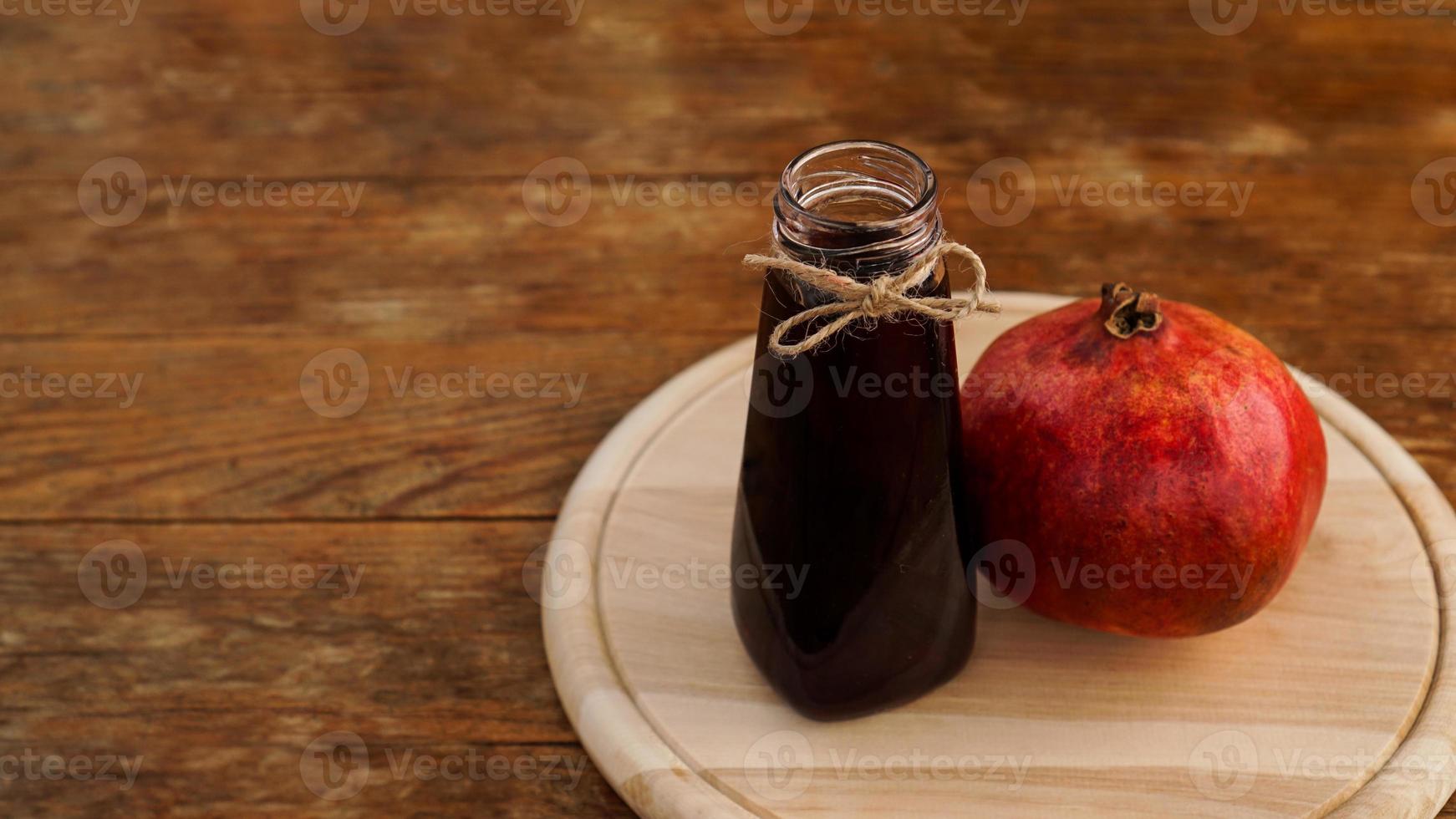 Ripe pomegranates with juice on wooden background. photo