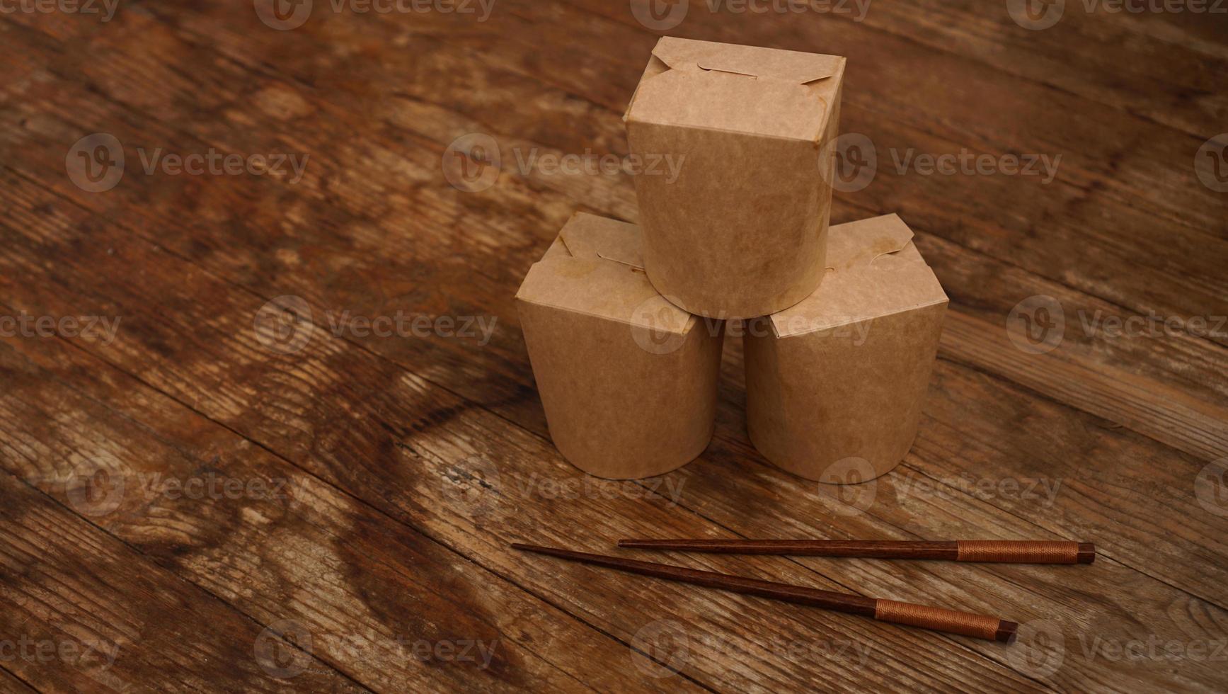 Brown paper cardboard food container on wooden photo