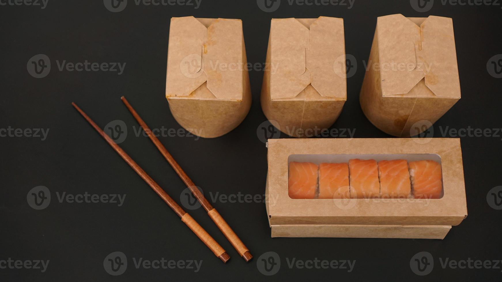 Asian food delivery. Packaging for sushi and woks photo