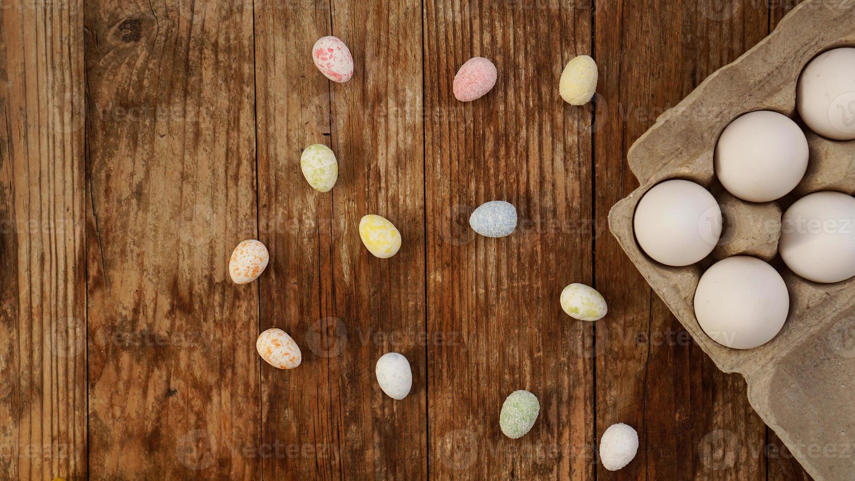 Chicken eggs in a cardboard tray and Easter decor photo