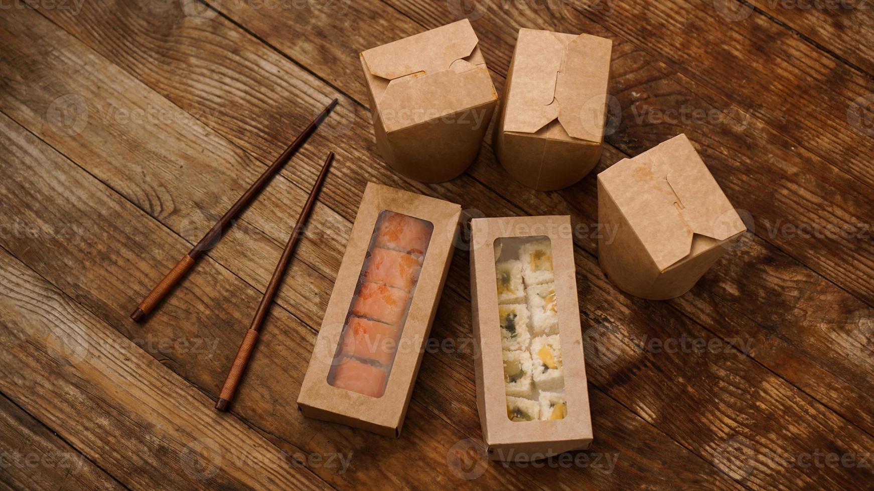 Asian food delivery. Packaging for sushi and woks photo