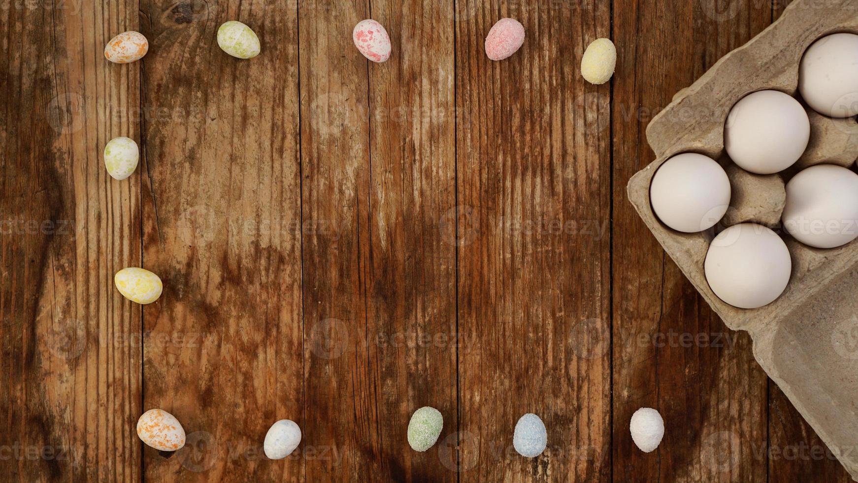 Chicken eggs in a cardboard tray and Easter decor photo