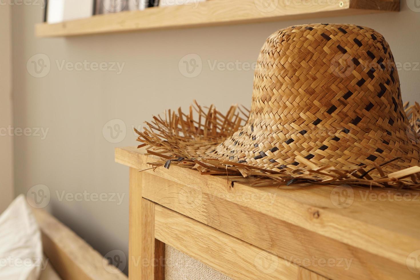 Straw hat on the shelf in room in a Scandinavian style photo